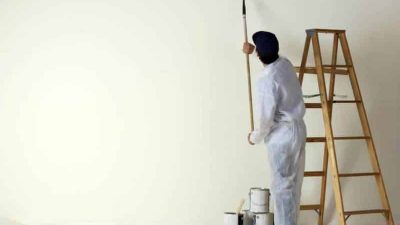 painting contractor painting with a roller